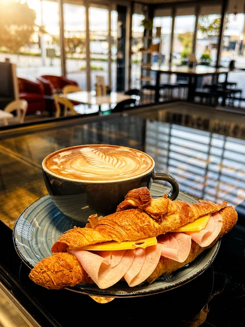 Coffee with a ham and cheese croissant