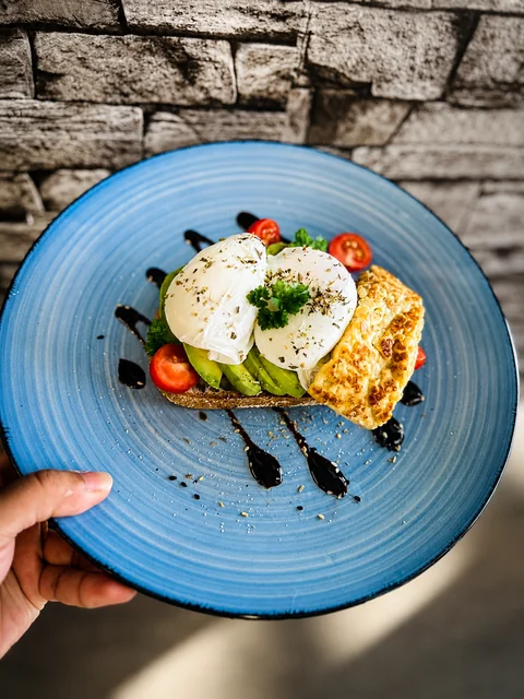 Avocado toast with poached eggs and grilled halloumi