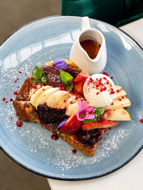 Sweet waffles with fruit, ice cream and berry compote