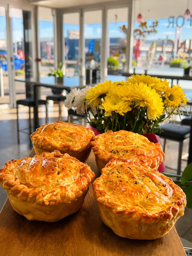 Golden savoury pies displayed in the Nash Cafe dining area